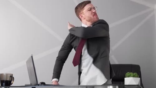 Angry Businessman Yelling at Desk in Office