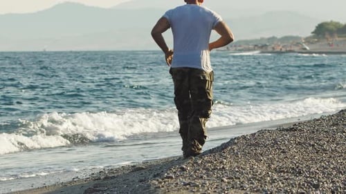 Man Runs on Scenic Rocky Beach