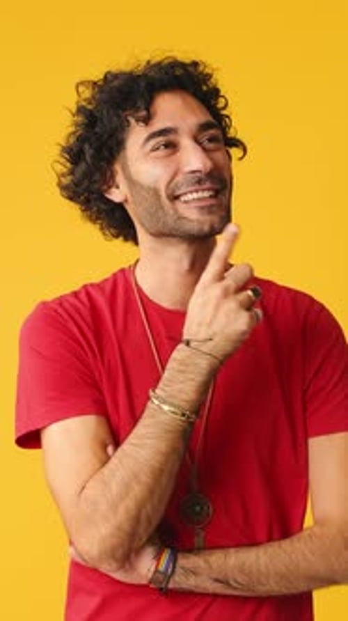 Pensive man thinking something, having good idea isolated on yellow background in studio
