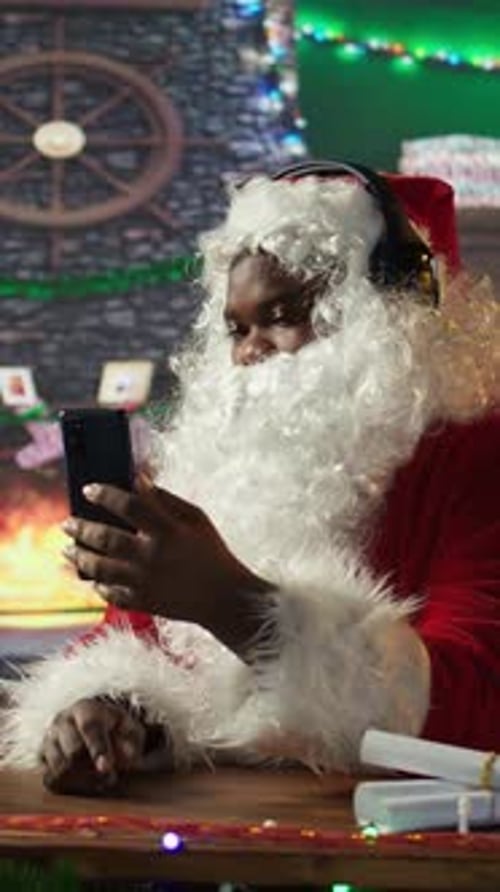 Vertical Video Cheerful Saint Nicholas Listening to Festive Carols Christmas Music on Phone