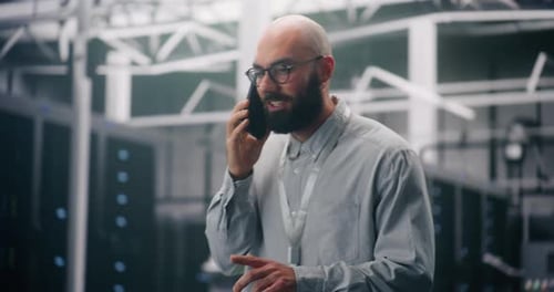 Man Talking on Phone in Server Room