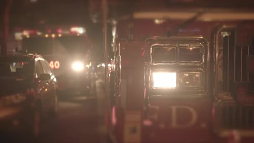 Fire Department Service Truck with Flashing Siren Lights at Night