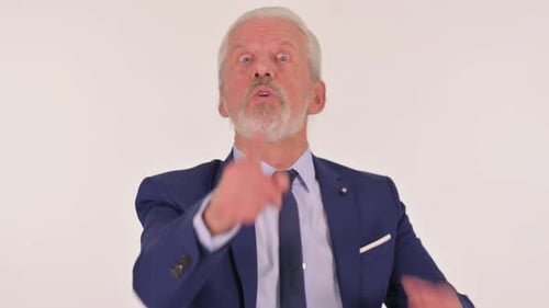 Senior Man Angrily Gesturing in a Blue Suit