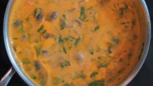 Bright Orange Soup with Meat and Vegetables is Bubbling