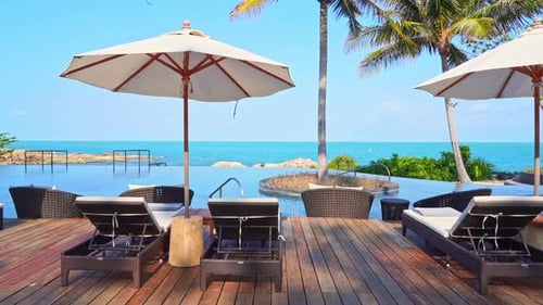 Luftaufnahme einer fantastischen exotischen Infinity-Pool-Lounge, umgeben von Kokospalmen