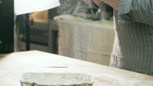 Baker Kneading Fresh Dough in Kitchen