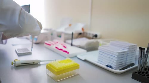 Gloved Hand Using Pipette for Clinical Lab Test