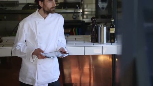 MS TU Chef using digital tablet in commercial kitchen / Breda, Noord-Brabant, Netherlands.