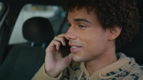 Young Man Using Smartphone in Car
