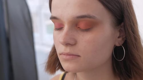 Makeup Artist Applying Makeup to Model's Face Close Up View