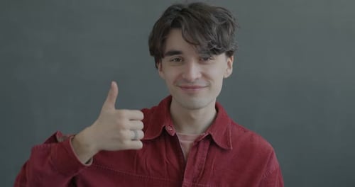 Man Giving Thumbs Up in Studio