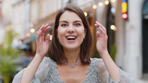 Young Woman Looking Surprised at Camera Shocked By Sudden Win Good Victory News Wow in City Street