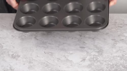 Lining Cupcake Baking Pan with Foil Cupcake Liners to Bake Unicorn Rainbow Chocolate Cupcakes