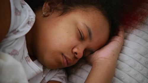 Child Sleeping Peacefully in Bed Close Up
