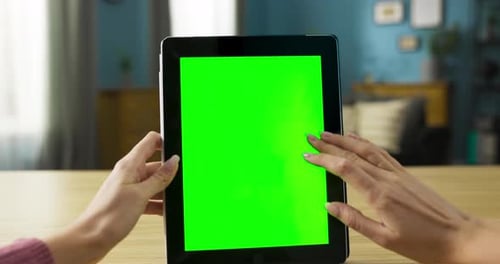 Woman Using Tablet with Green Screen Indoors