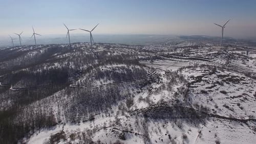 many wind turbines on top of a mountain