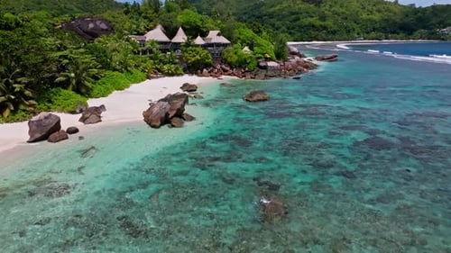 Mahè island, Seychelles. Aerial drone view of exotic white sanded beach on tropical island surrounde