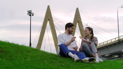 Young Woman Accepts the Marriage Proposal of Her Partner and They Exchange Kisses in a Public Park