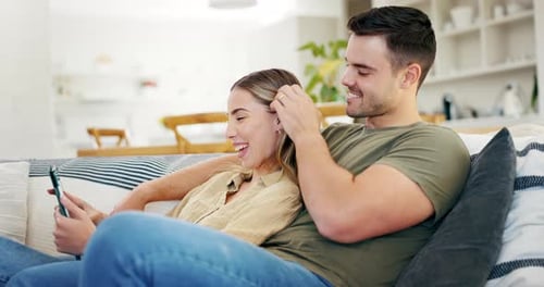 Affectionate Couple Enjoying Tablet Together on Couch