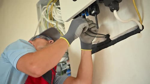 Man Working on Electrical Wiring of Solar Panel