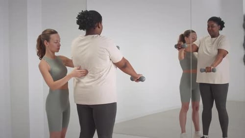 Plus Size Black Woman Training with Coach in Studio
