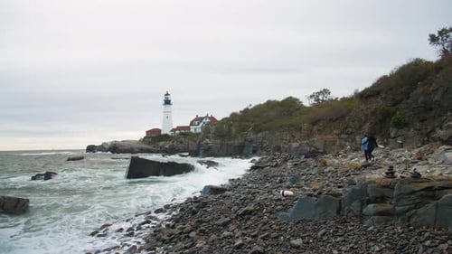 Couple On Beach Towards Lighthouse, Waves Crashing New England Coast