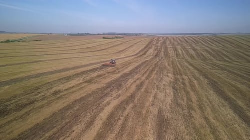 Tractor working on the field doing tillage with cultivator
