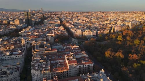 Experience the Breathtaking Aerial View of Madrid Gracefully Illuminated By Sunset Hues