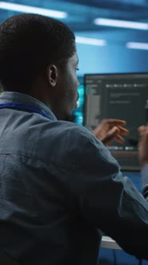 Young Adult Puts on Headset in Office