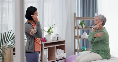 Physical Therapist Coaching Senior Woman on Arm Stretches
