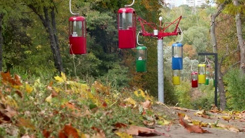 Colorful cableway cabins in autumn city park