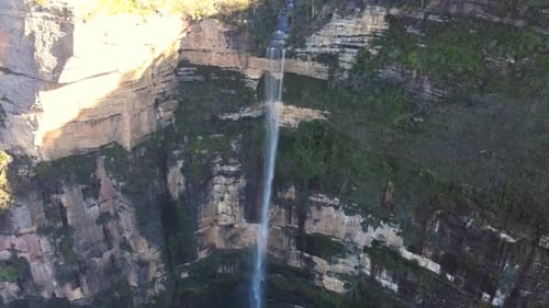 Drone view of a waterfall at high rocky cliff. 4K videos.