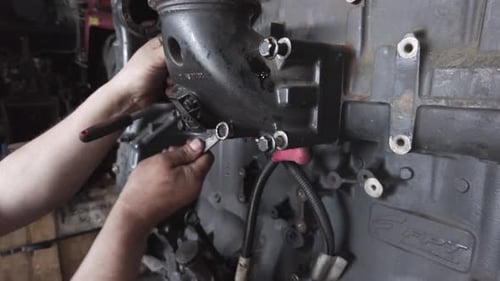 Mechanic Works on Heavy Machinery Engine Close Up