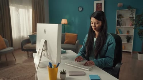 Young Adult Working at Computer in Modern Home