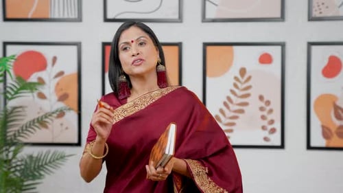 Woman Explains, Holds Notepad Indoors