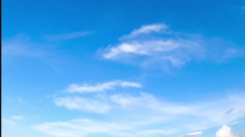 Amazing azure horizon with tiny threads of clouds. Summer day sky from low angle view. Timelapse.
