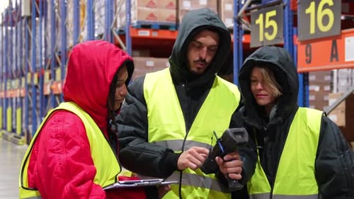 Warehouse Workers Using Barcode Scanner in Cold Storage