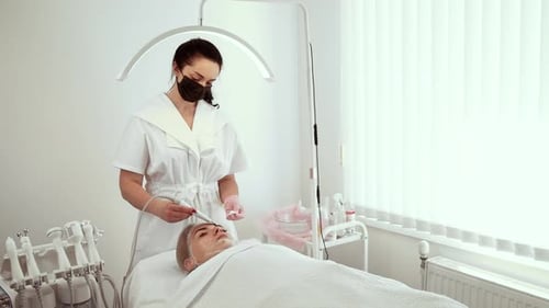 Cosmetologist Beautician Using Skin Spatula During Procedure at Dermatology Office Female Specialist
