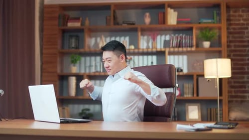Asian man worker stretching doing easy office exercises to relieve muscle tension from sedentary