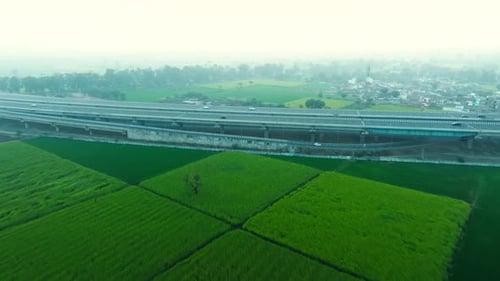 Aerial view of highway passing through fields, India.