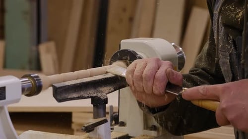 Close Up Carpenter at Workshop Polishes Wooden Board with a Electric Orbital Sander Woodwork and