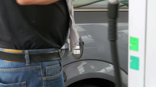 Man Filling Car with Diesel Fuel Man's Hand Using a Petrol Pump to Fill His Car Up with Fuel