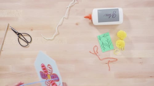 Child Sewing Yarn Through Flower Art Project