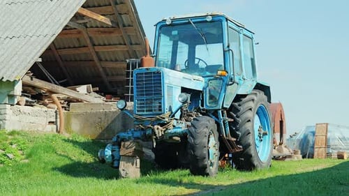 Static Shot Of Old Soviet Era Tractor Awaiting Repair In Farmyard