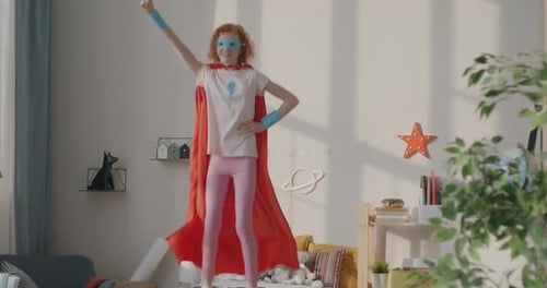 Girl in Superhero Costume Dancing on Bed