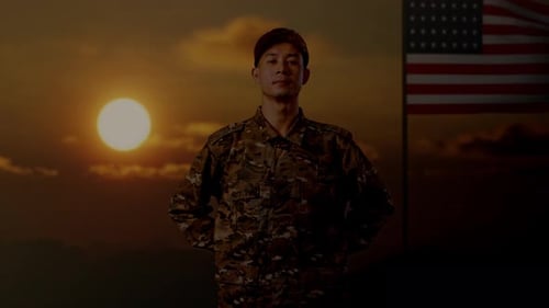 Soldier Standing with American Flag at Sunset