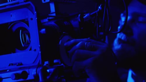Cameraman Adjusting Focus while Shooting Commercial in Studio