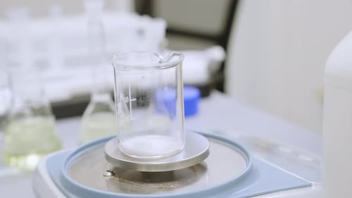 Close Up of a Woman Weighing Powder Samples Using Laboratory Balances