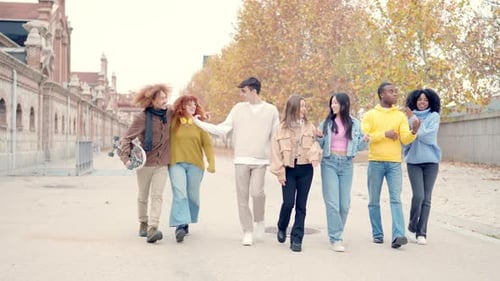 Multiethnic Friends Chatting and Walking Relaxed in the City