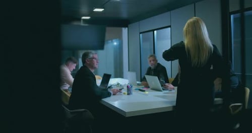 Diverse Team Collaborating During an Evening Office Meeting